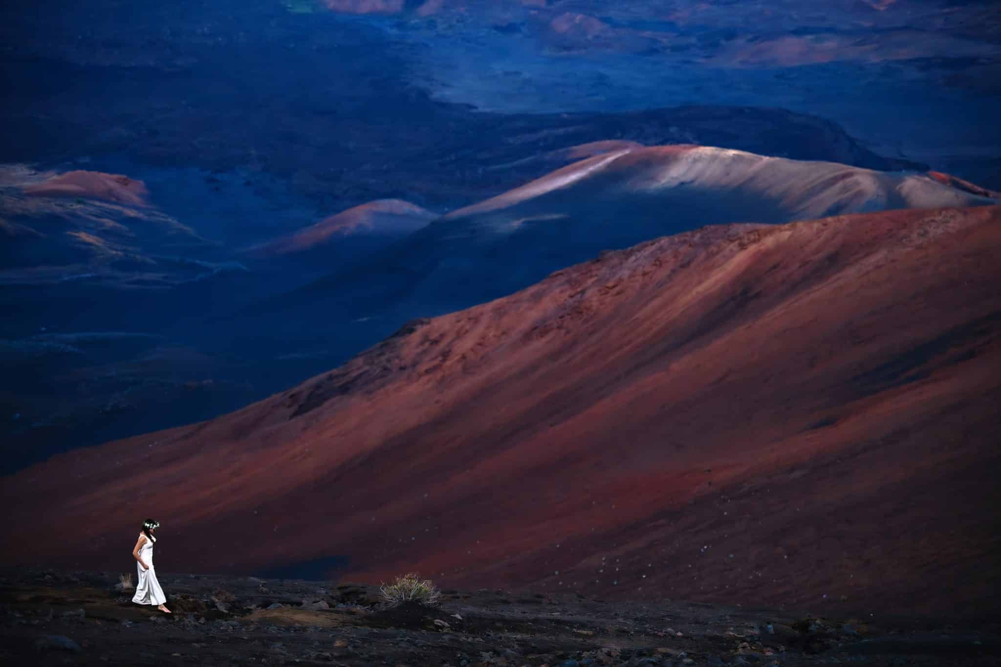 Cheryl walking along Haleakala with the view behind her