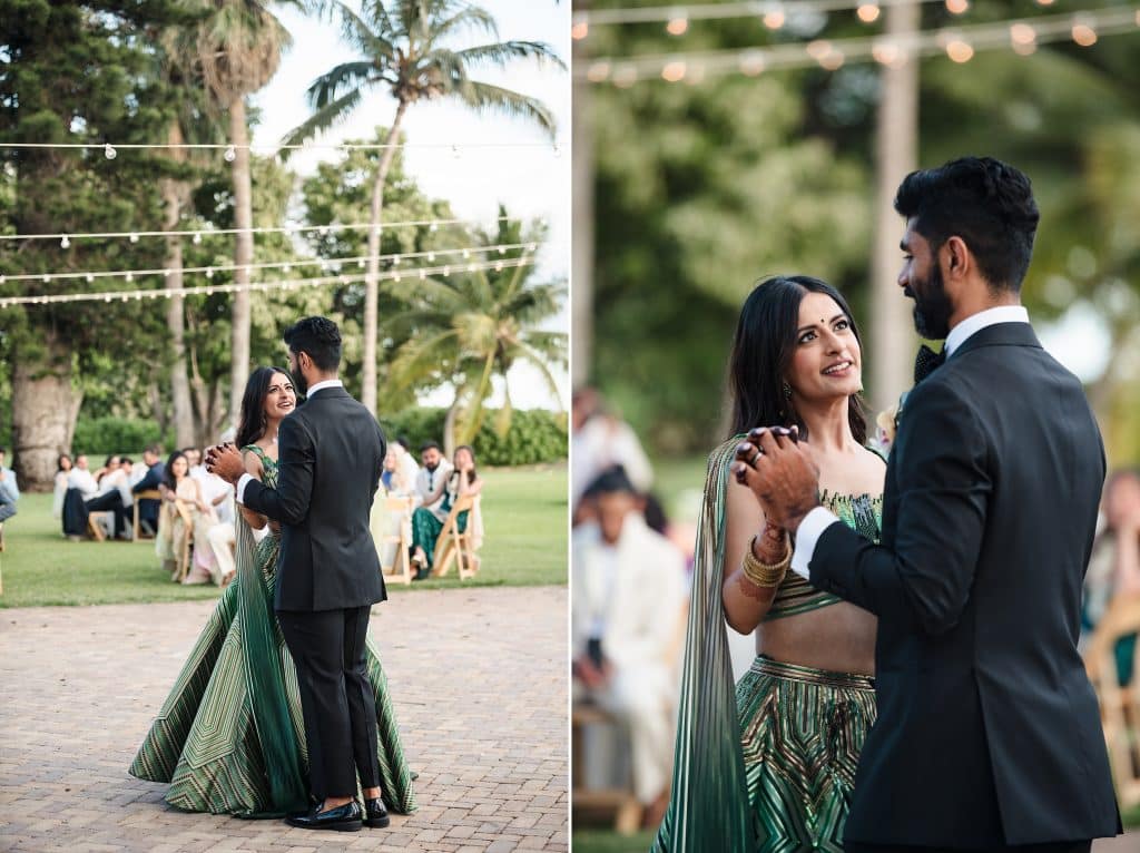Indian-Wedding-in-Maui-_0034 - Ann Arbor Wedding Photographer Couple dancing at an outdoor garden wedding under string lights, with guests seated in the background.